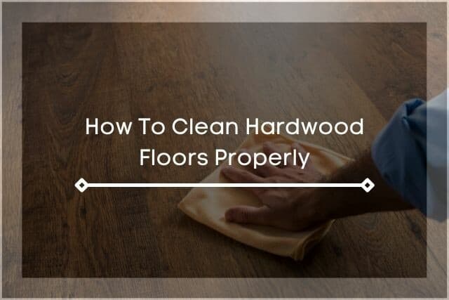 Hand wiping hardwood floor with hand towel