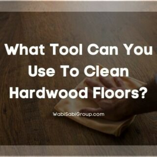 Hand using microfiber cleaning cloth to wipe hardwood floor