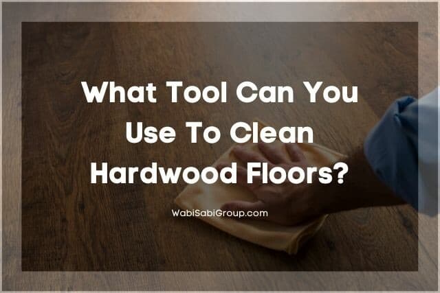 Hand using microfiber cleaning cloth to wipe hardwood floor