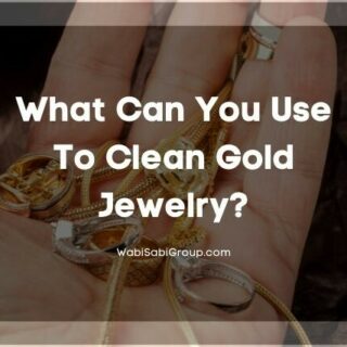 Hand holding a collection of gold jewelry
