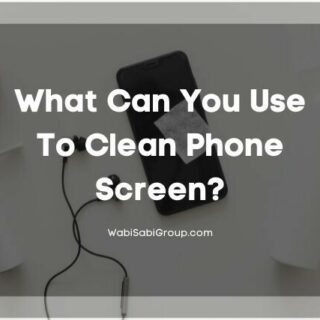 Phone, earphones, cleaning tools, laying on a white table