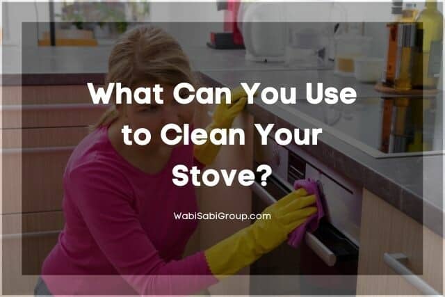 Woman in a pink shirt with gloves cleaning the stove