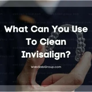 A photo of a dentist's hand holding a invisalign