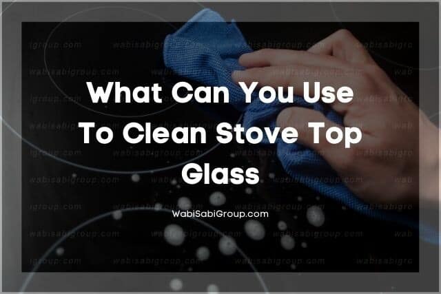 A close up shot of a person cleaning stove top glass