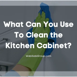 Showing of a person's hand cleaning the cabinet with gloves and towel