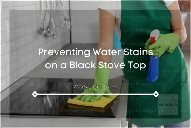 Wiping clean black stove top